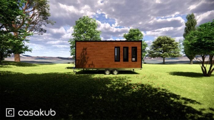 Vue arrière d'une tiny house moderne, entourée de nature, construite en bois.